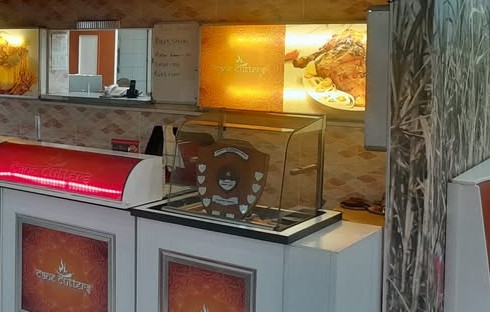 The service counter at Cane Cutters with a trophy shield displayed on the right